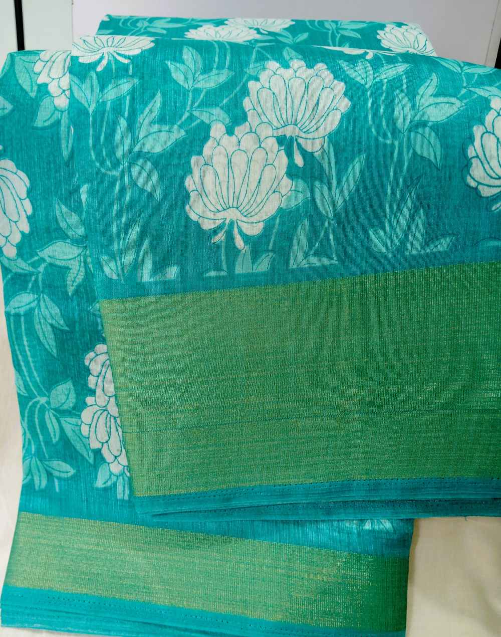 teal green floral print semi cotton saree
